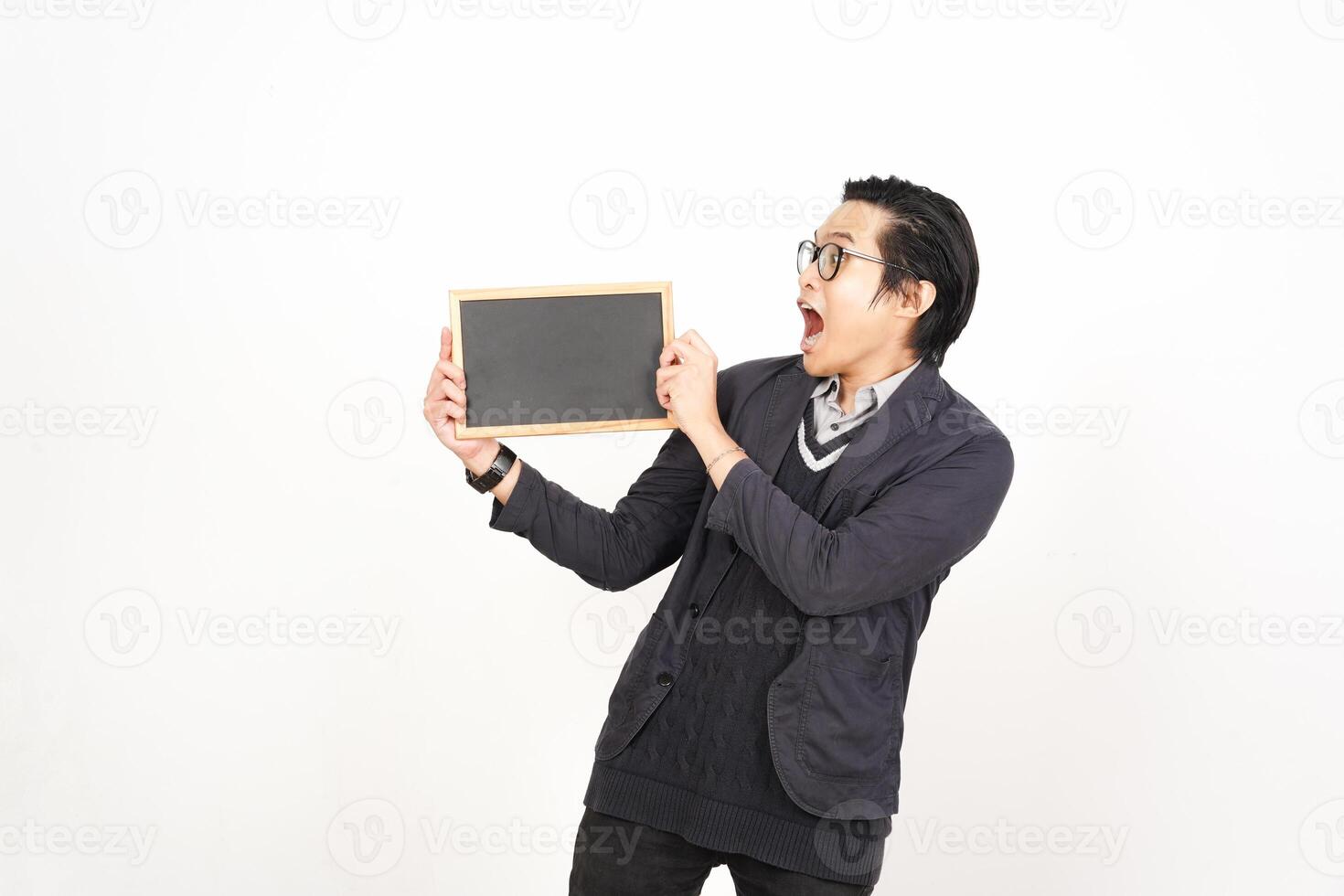 A man holding a blackboard while looking at it photo