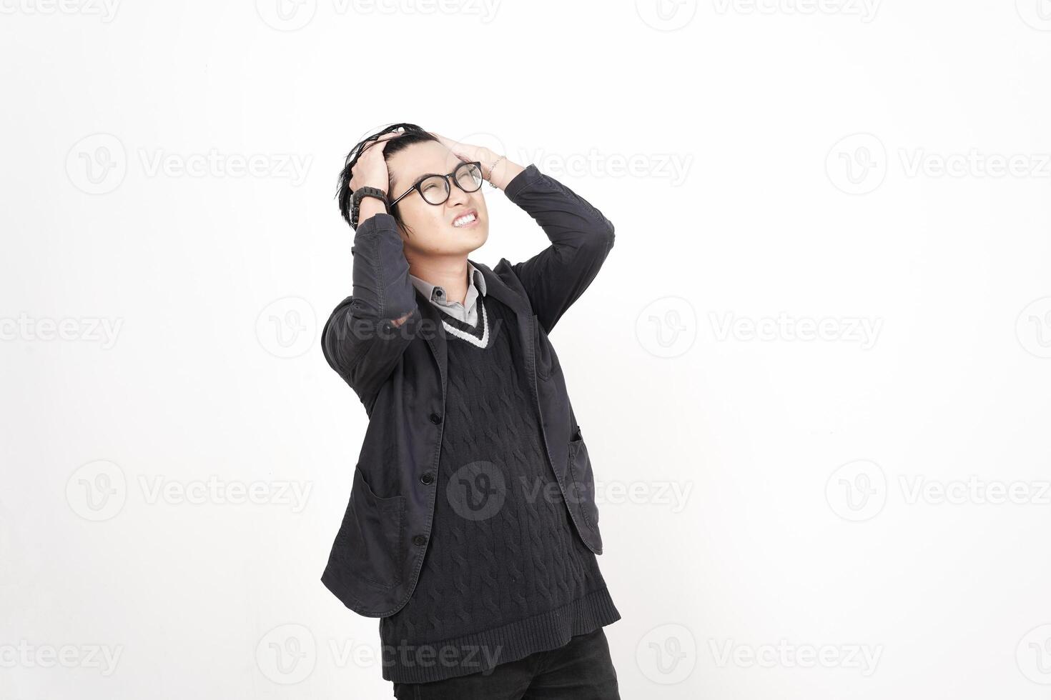 A man in glasses and a sweater is standing with his hands on his head photo
