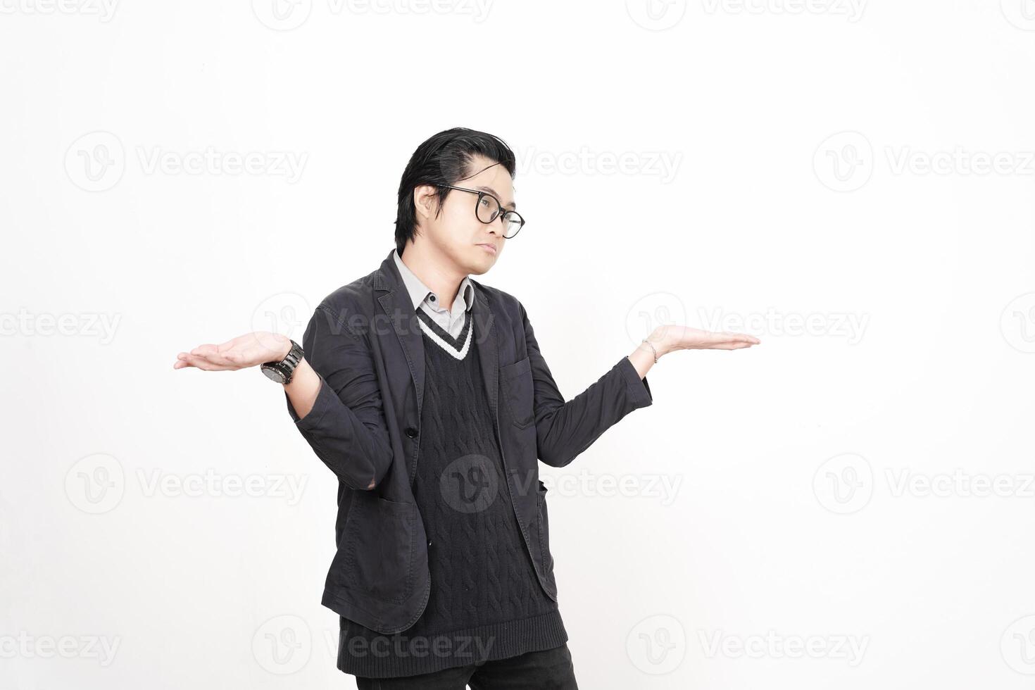 A man in glasses and a black jacket is standing with his hands out photo