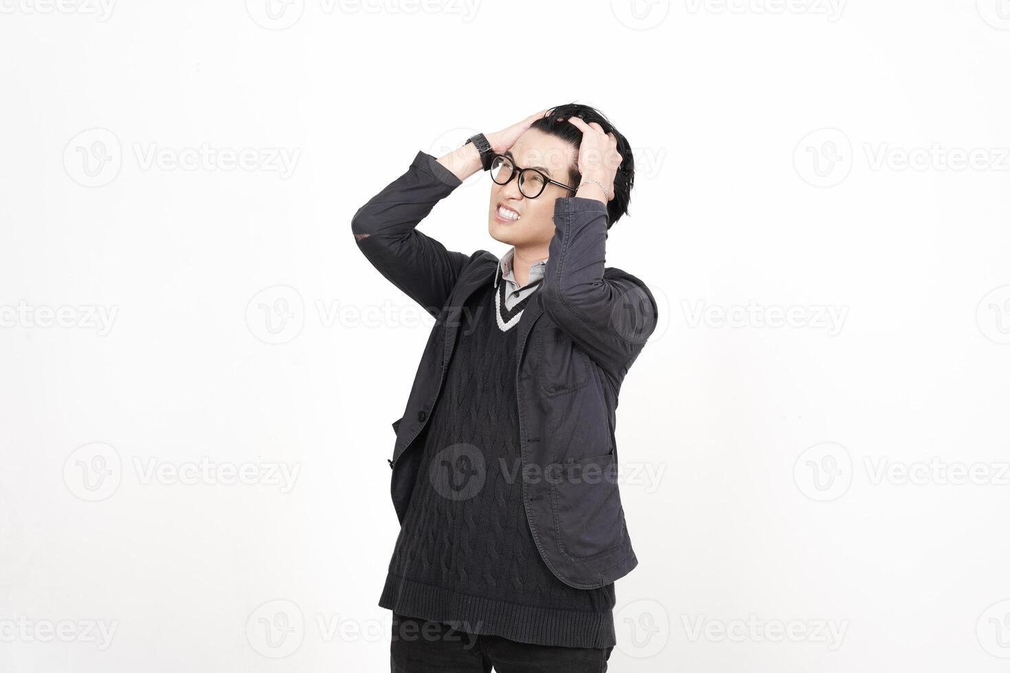 A man in glasses and a black jacket standing in front of a white background photo