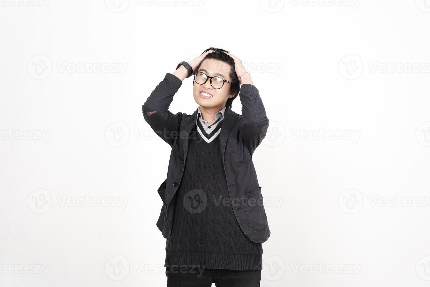 A man in glasses and a sweater is standing in front of a white background photo