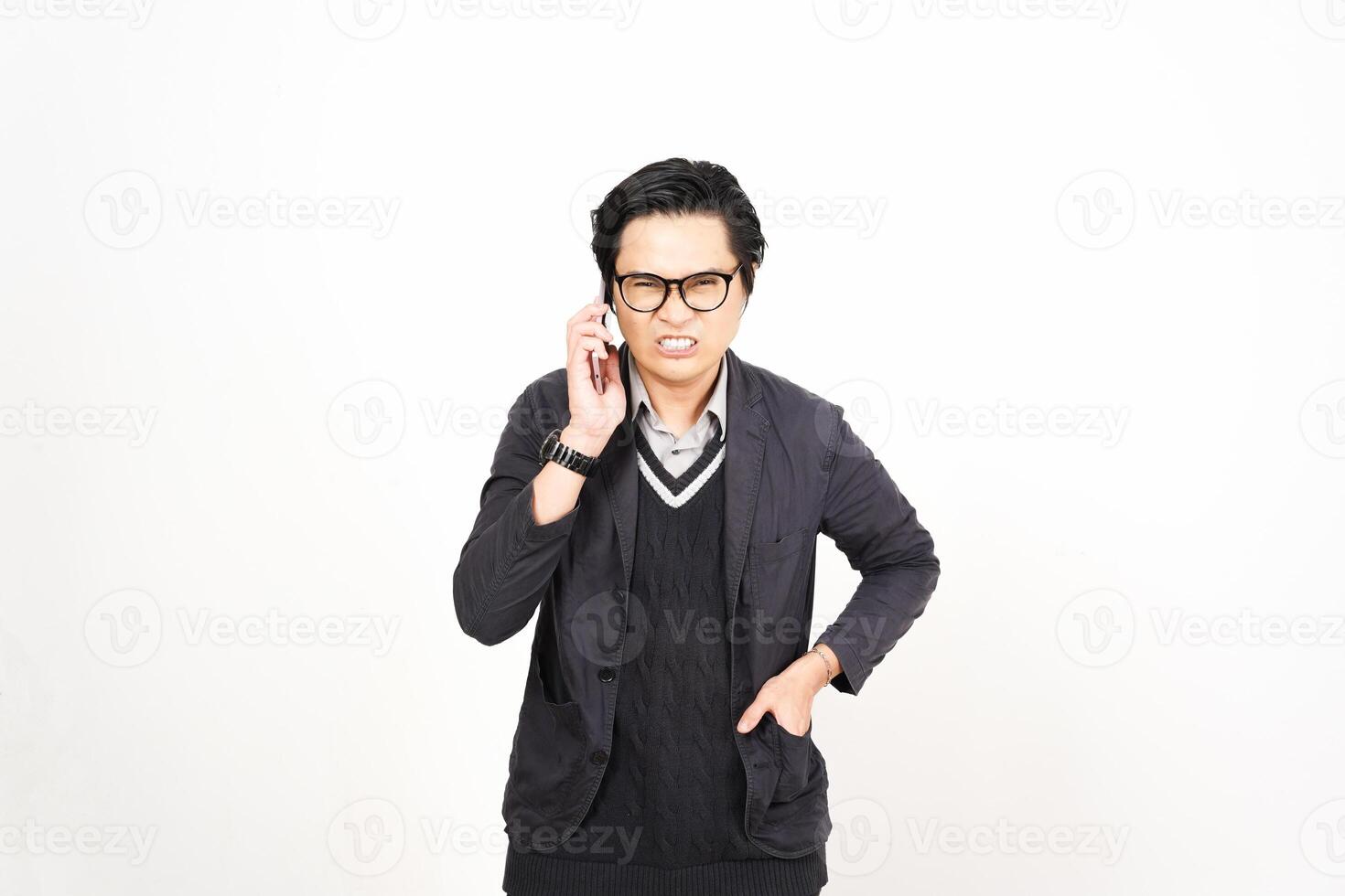 A man in glasses and a sweater talking on a cell phone photo
