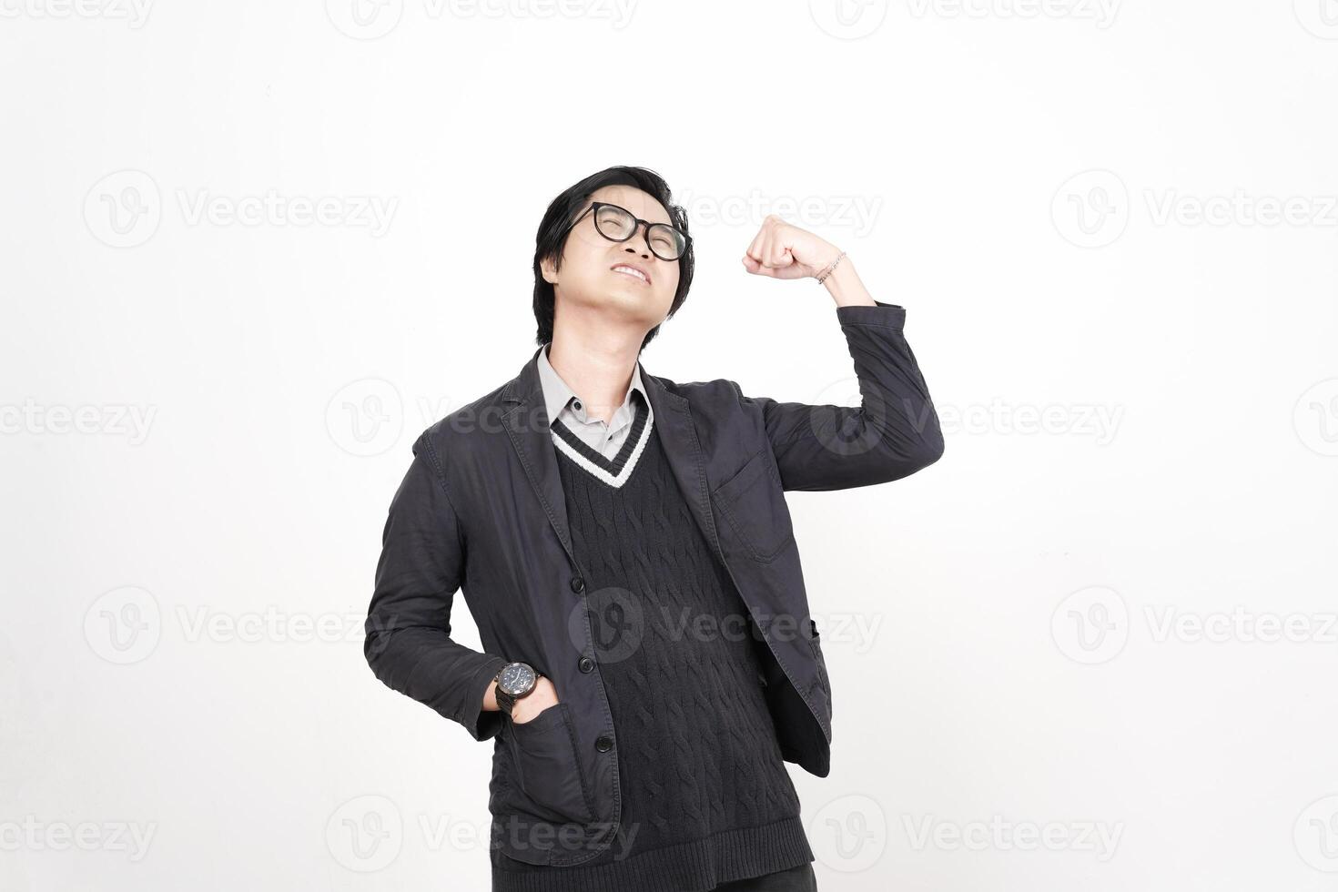 A man in glasses and a sweater is standing with his arms up photo