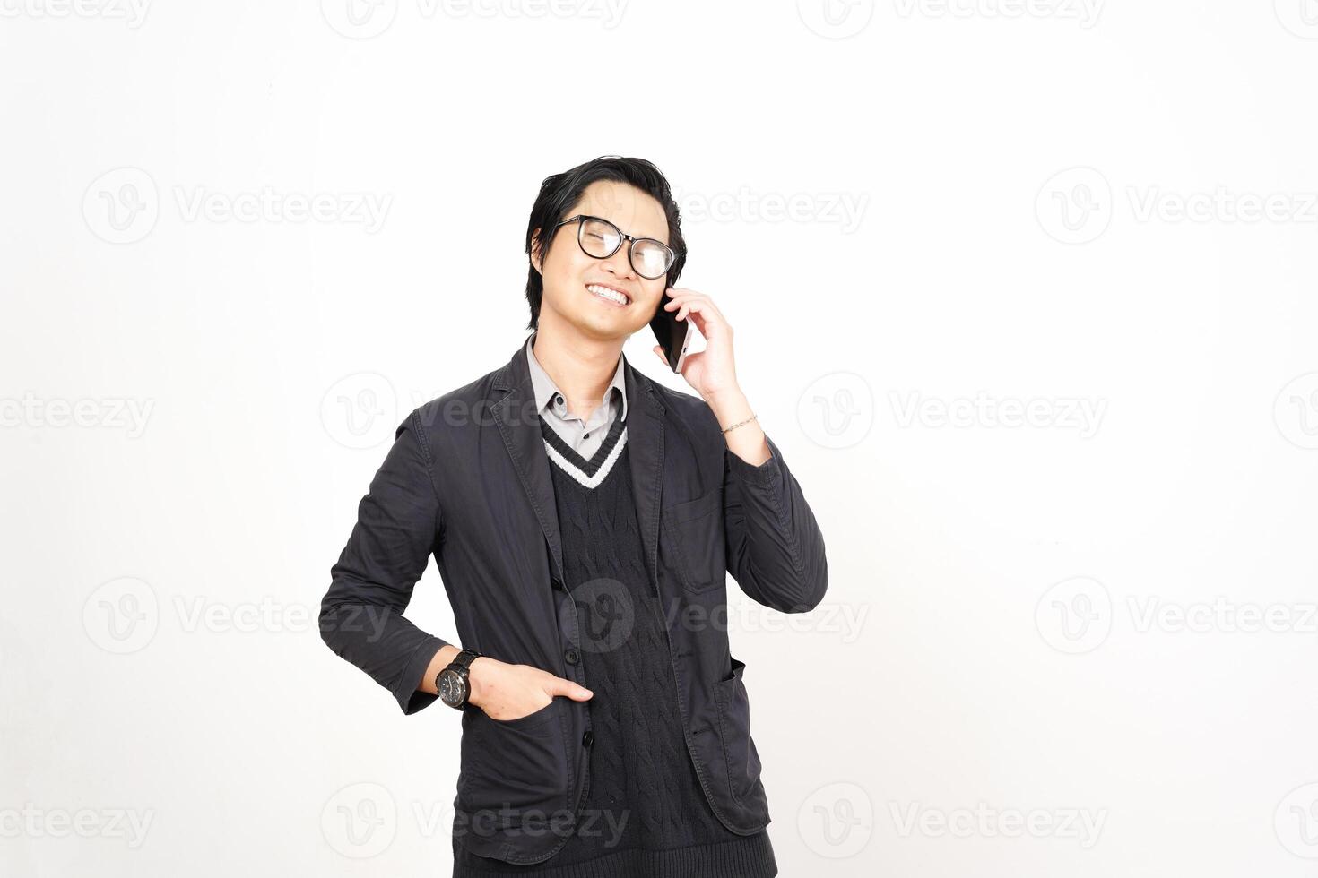 A man in glasses and a sweater talking on a cell phone photo