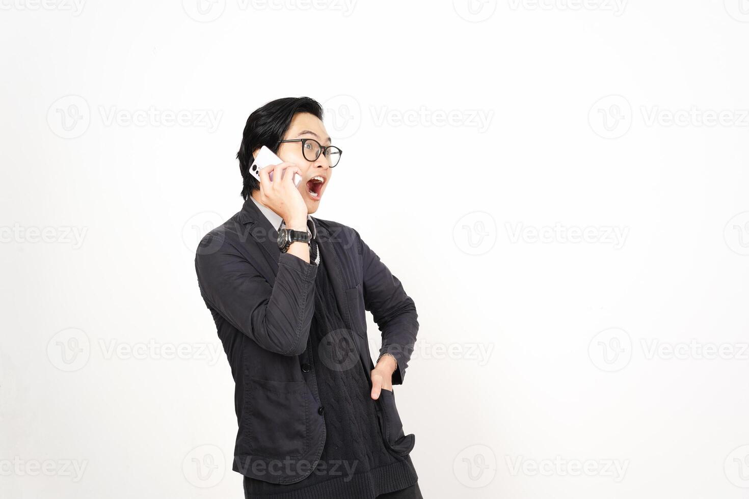 A man in glasses and a suit talking on a cell phone photo