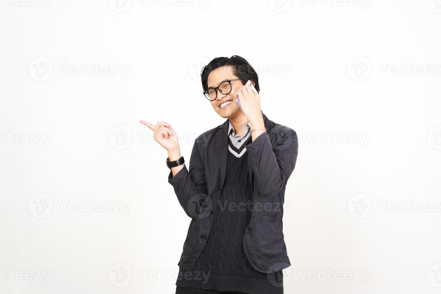 A man in glasses and a sweater is talking on his phone photo