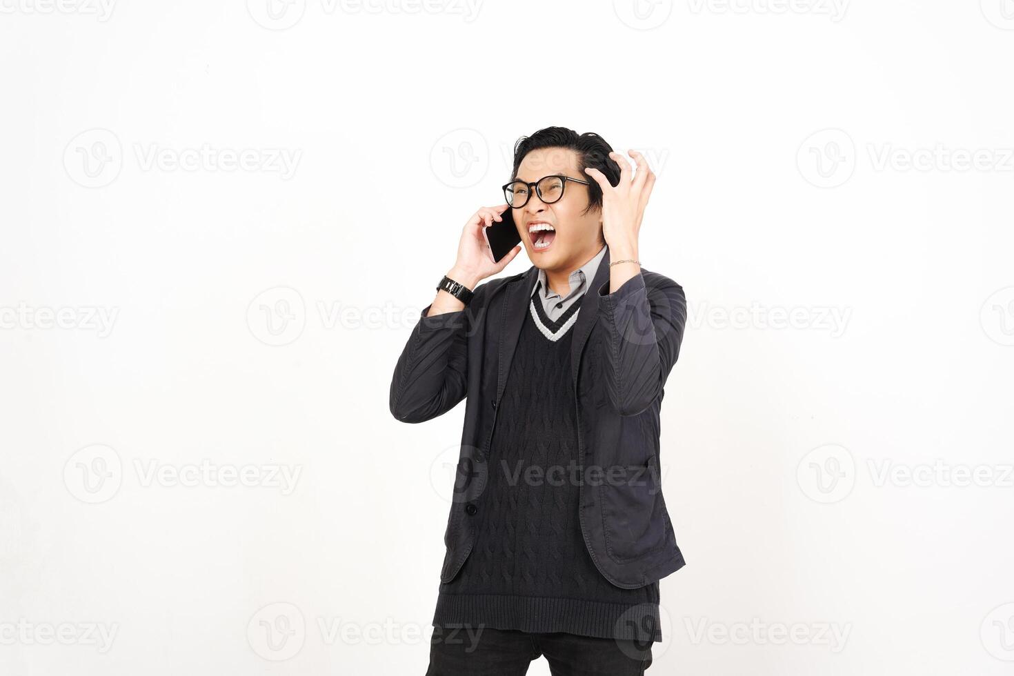 A man in glasses and a sweater is talking on a cell phone photo