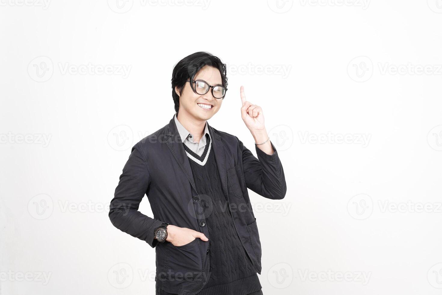 A man in glasses and a jacket is pointing to something photo