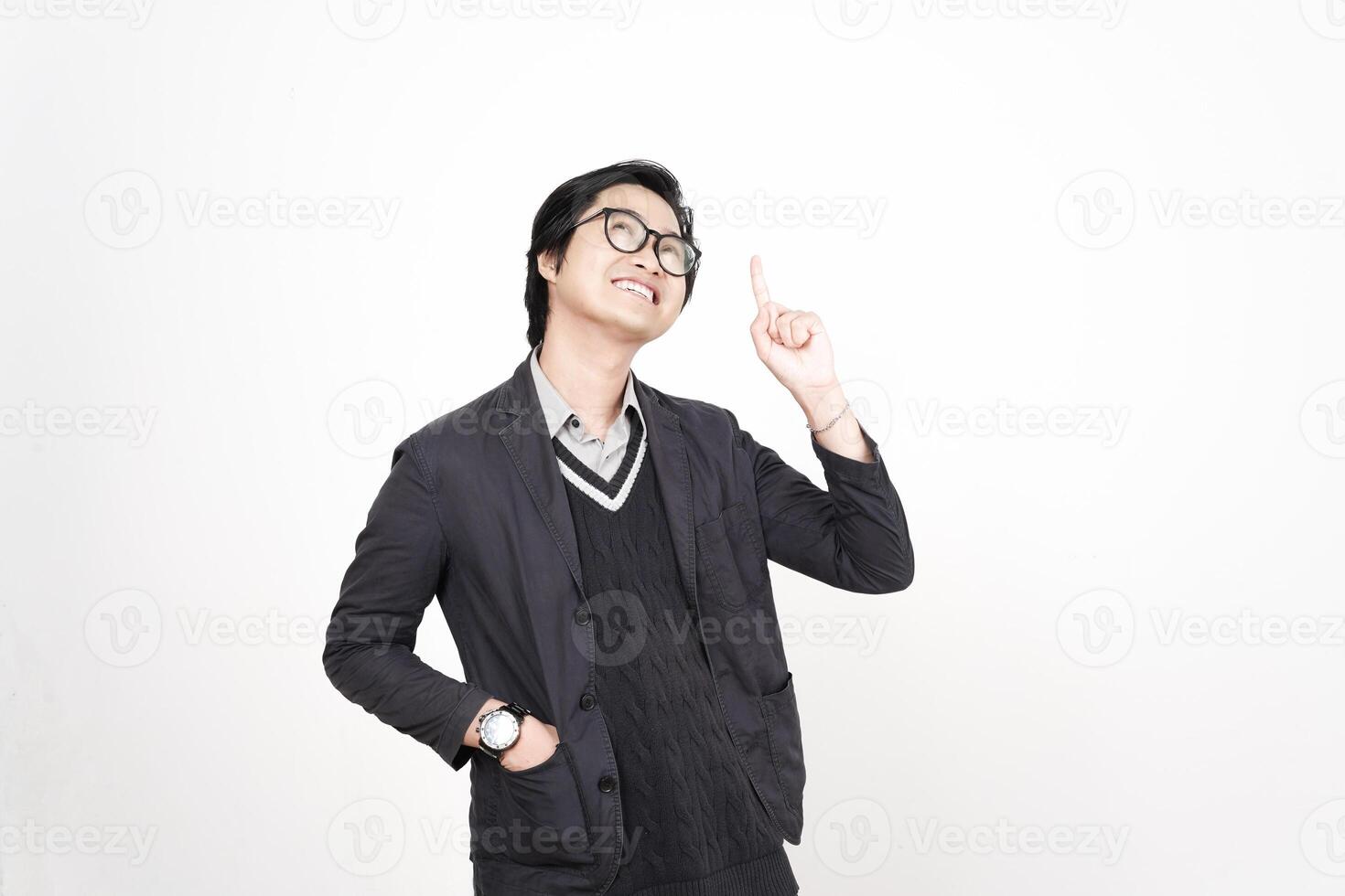 A man in glasses and a suit is pointing up photo