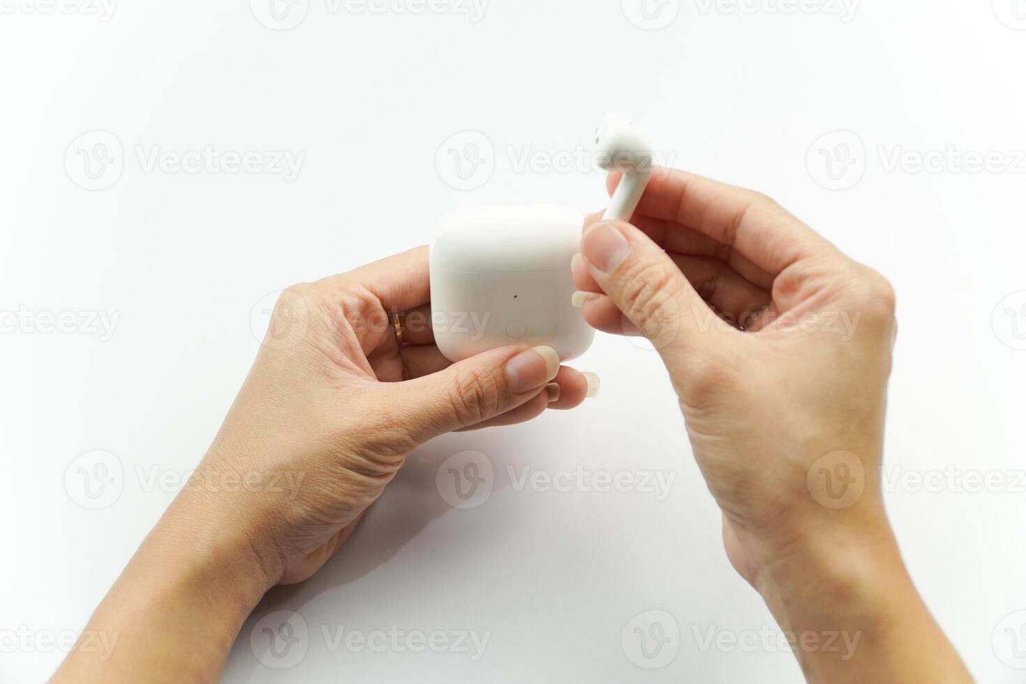 A person holding a white object in their hand photo