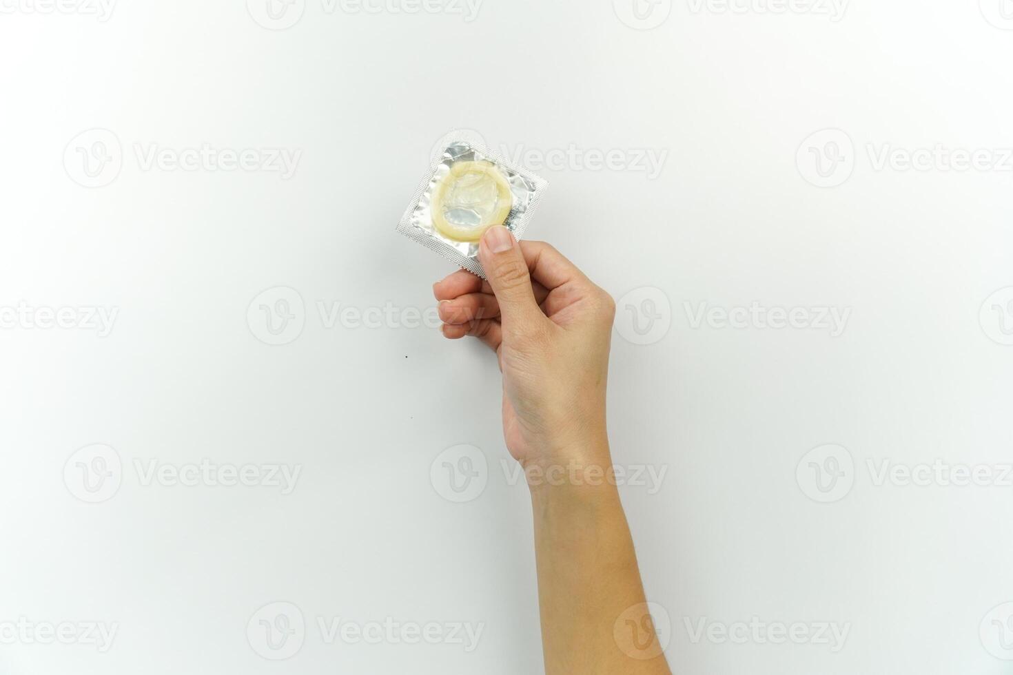 A person holding a condom in their hand photo