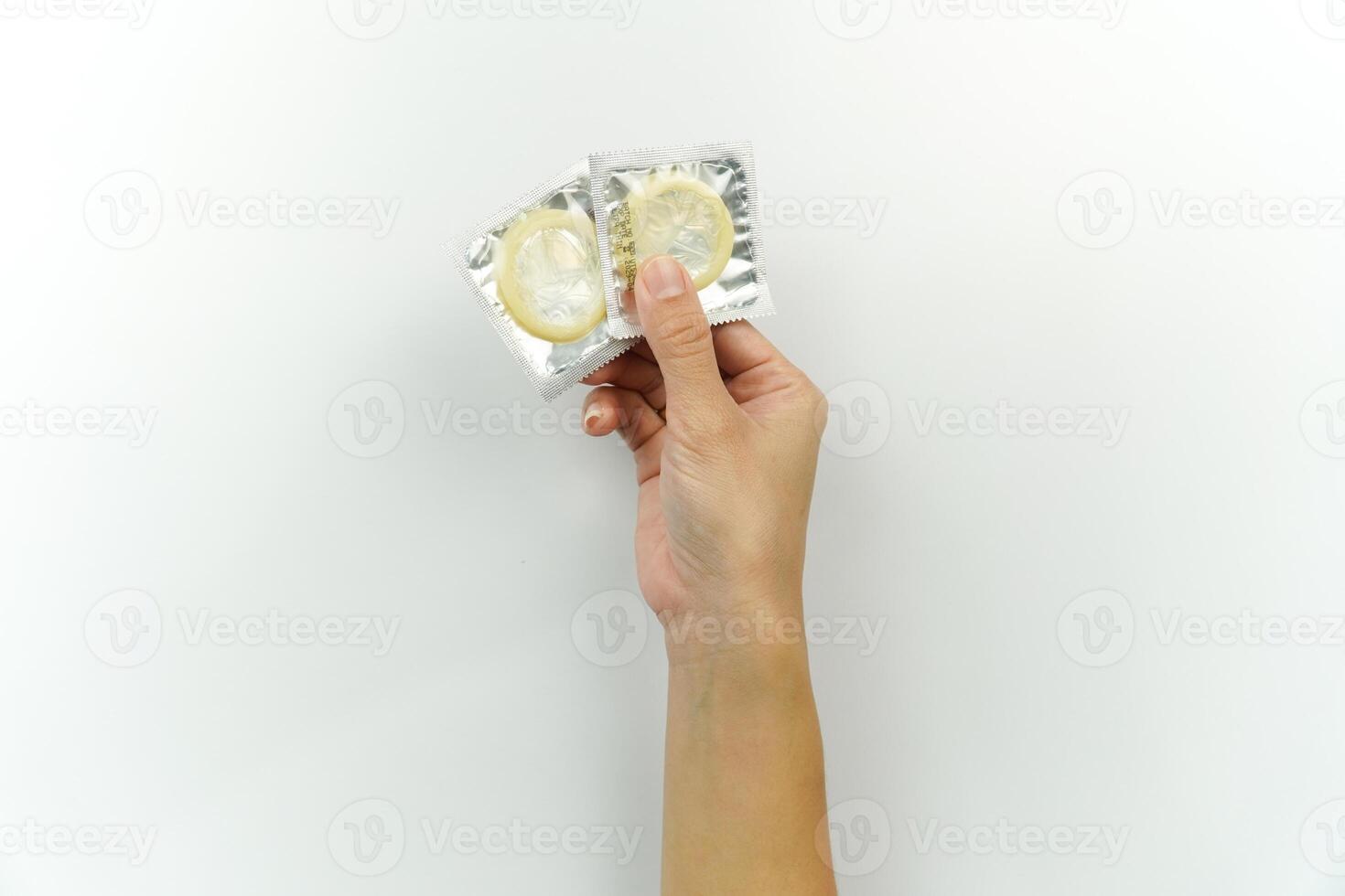 A person holding a condom in their hand photo