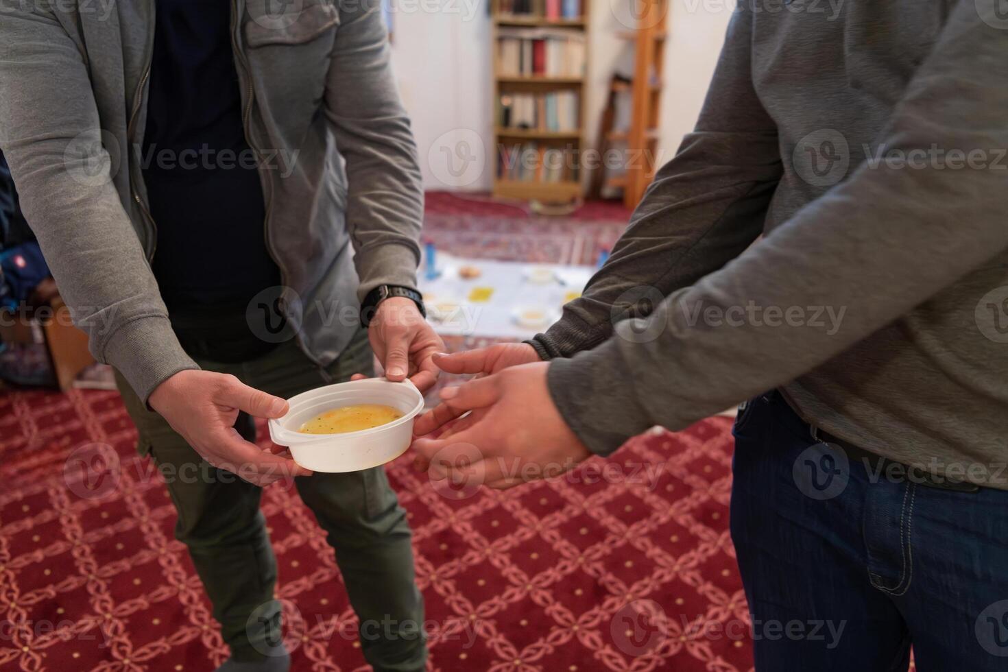 Top view of people serving food at a Mosque a communal meal during Ramadan before breaking the fast on Iftar dinner. Warm festive atmosphere celebrating Ramadan Karim and Eid, the Islamic holy month photo