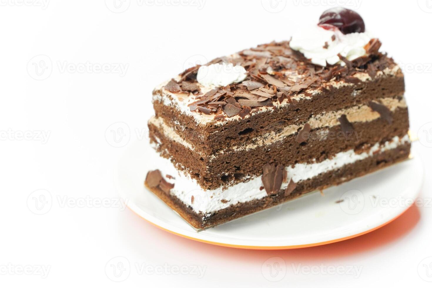 A piece of chocolate cake with a cherry on top photo