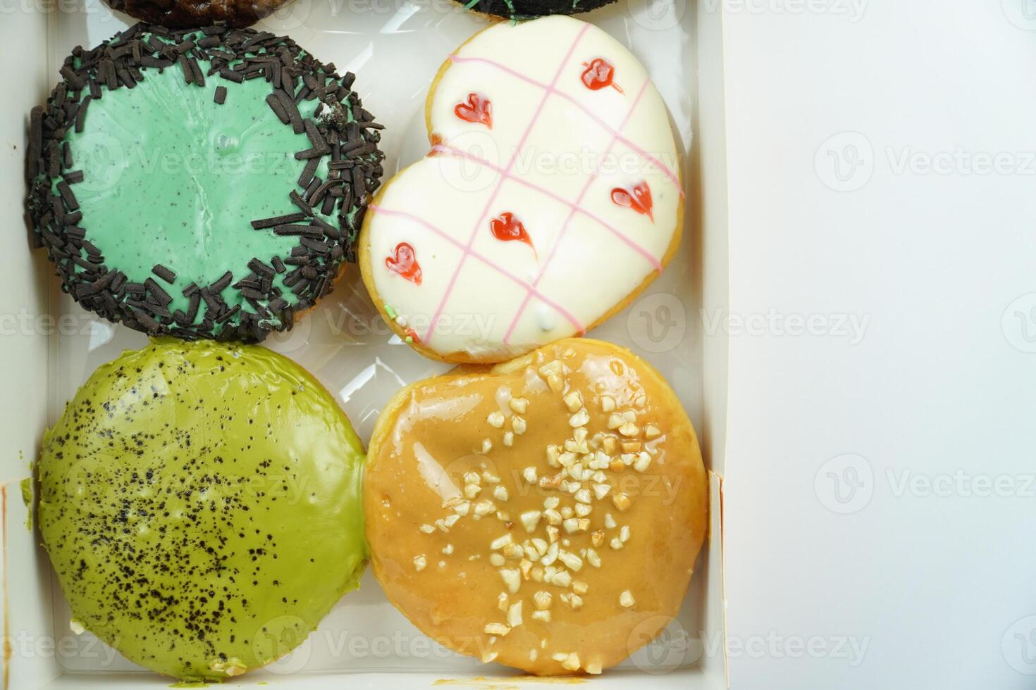 A box of donuts with different designs photo