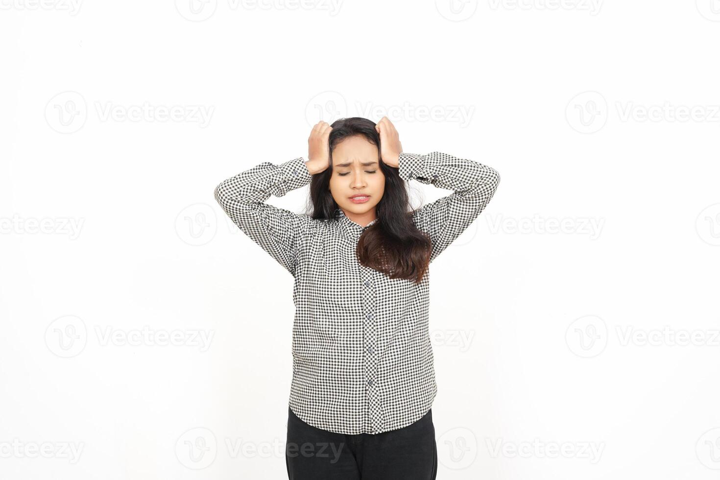 A woman is holding her head with both hands photo
