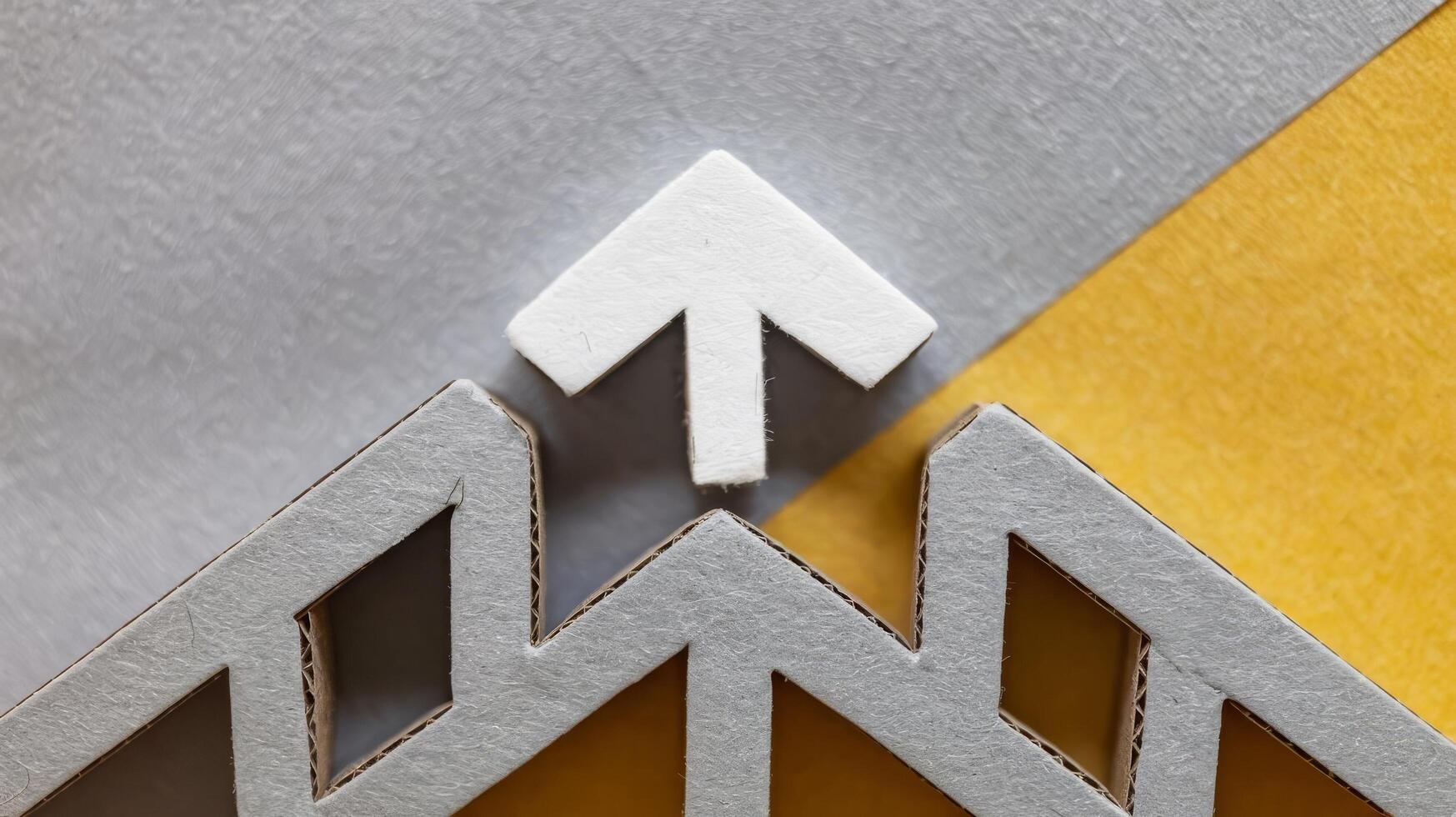A white arrow pointing up on a yellow and gray background photo
