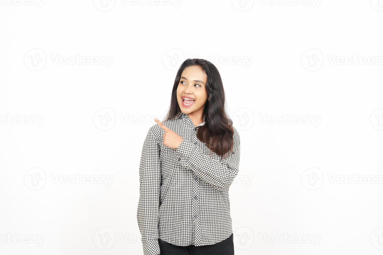 A woman in a shirt pointing at something photo