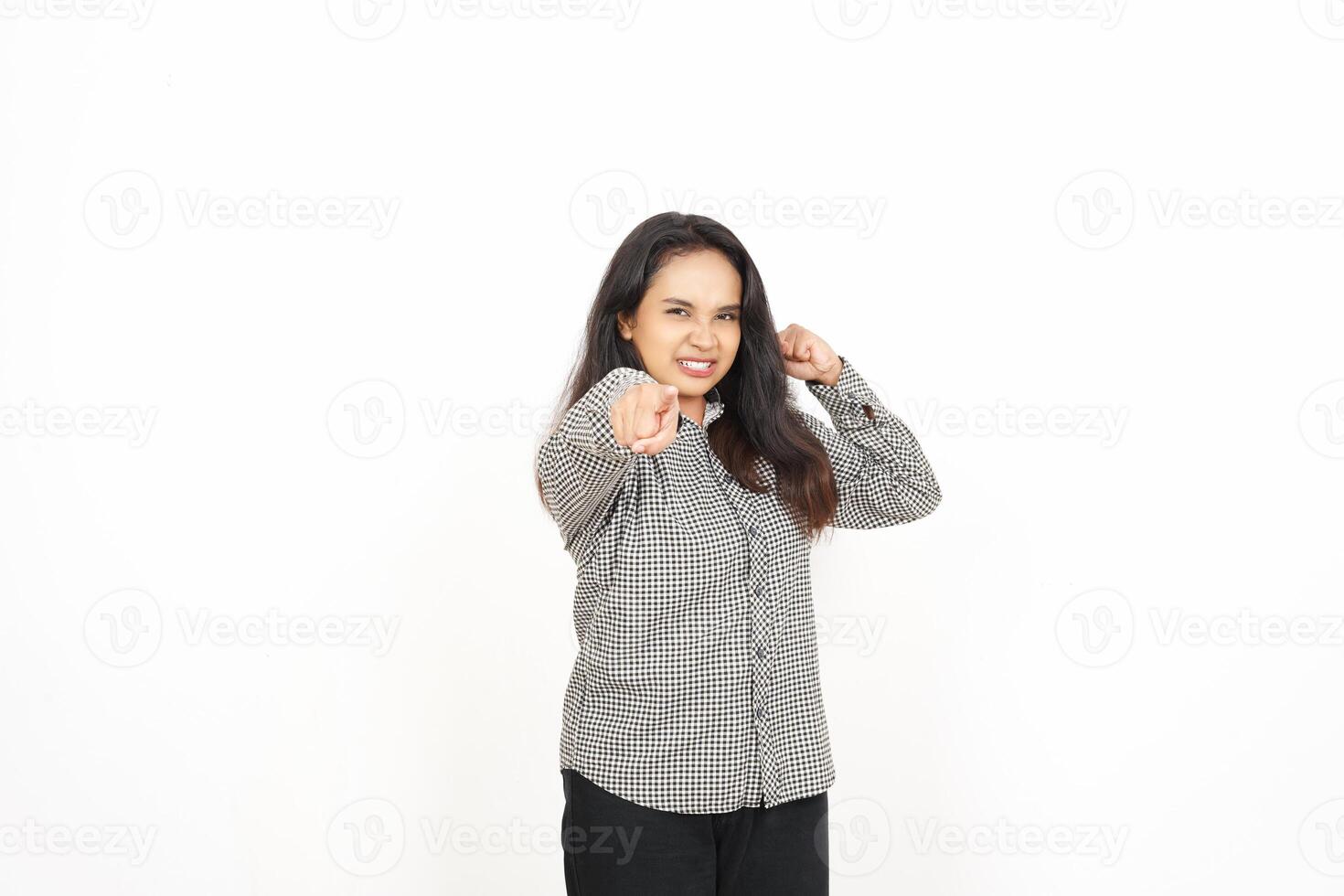 A woman in a shirt and pants pointing at something photo
