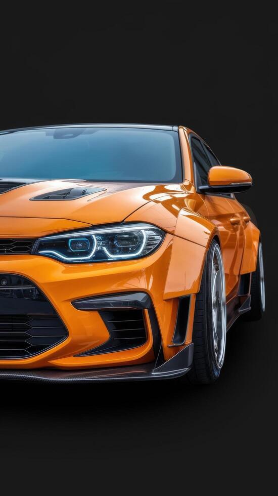 Front headlights of orange modify car on black background copy space photo