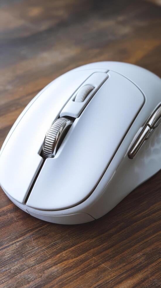 A white computer mouse on a wooden table photo