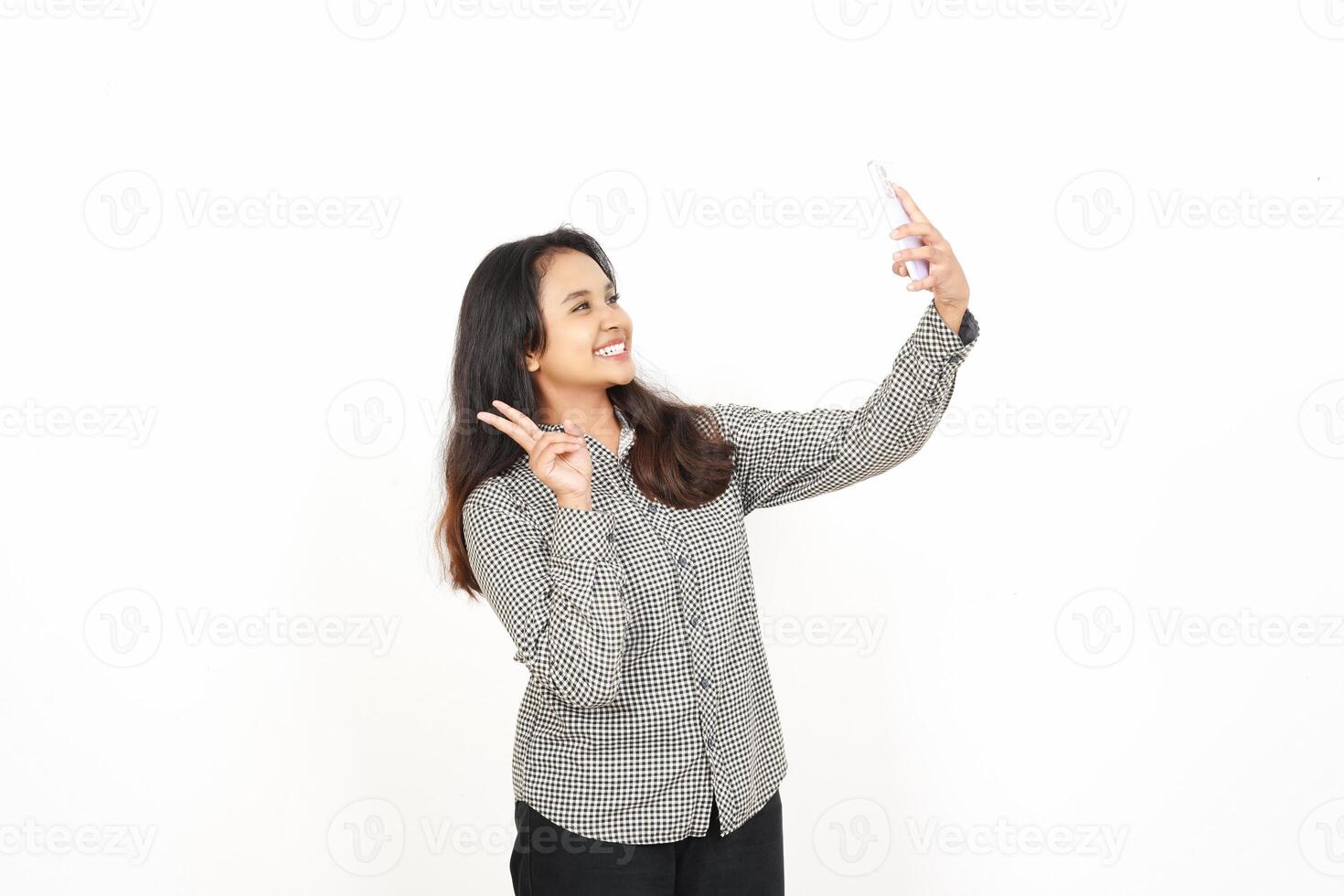 A woman is taking a selfie with her phone photo