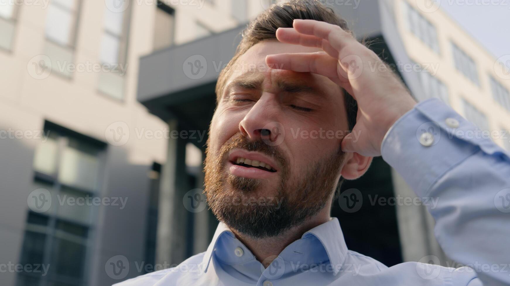 Frustrated stressed disappointed Caucasian male holding mobile phone error app failure lost upset loose bad news man businessman guy business chat smartphone problem online internet trouble in city photo