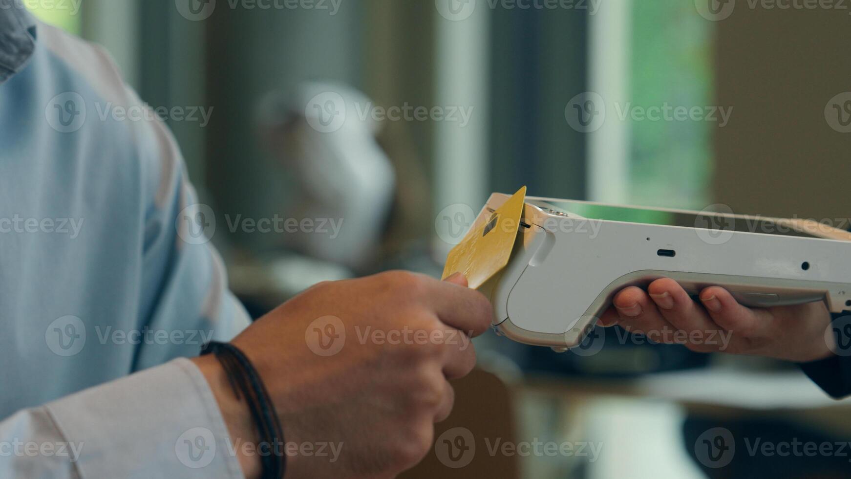 Customer pay food order lunch in cafe unrecognizable man contactless payment technology NFC credit card waiter serving visitor in restaurant guy paying bank app mobile terminal scan cashless service photo