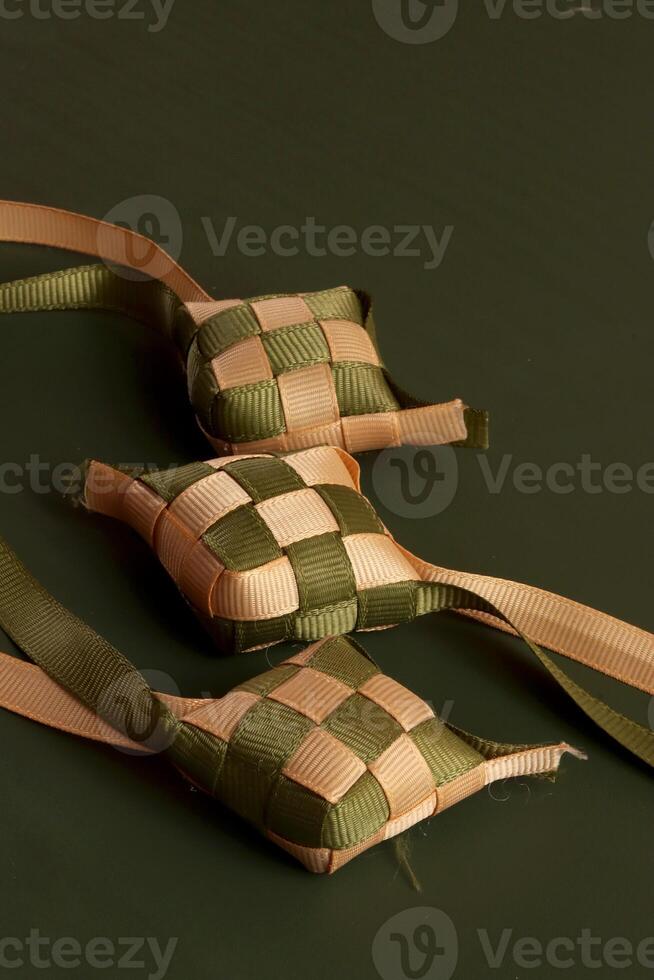 three small squares of fabric with ribbons tied to them photo