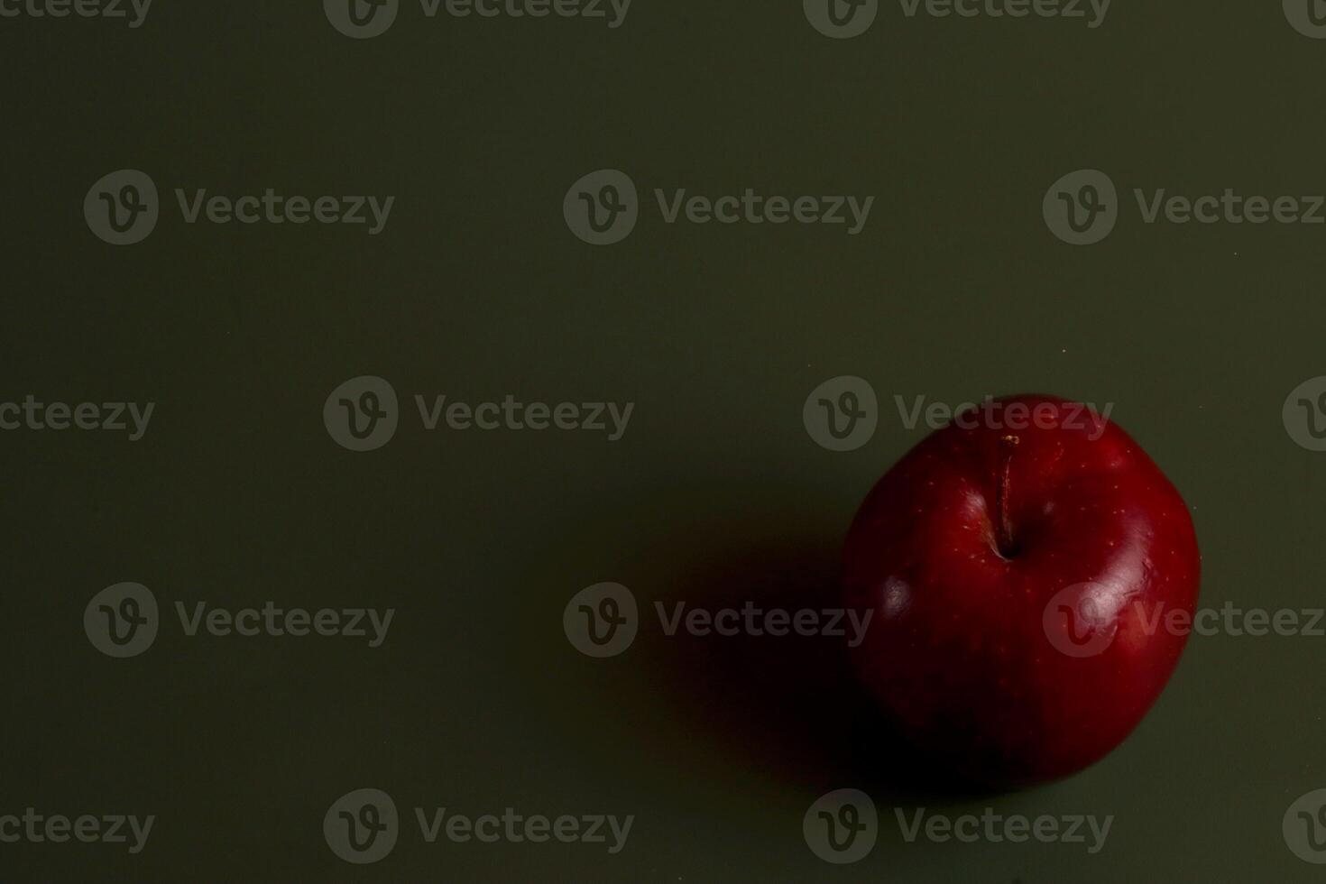 a red apple on a green surface eid photo