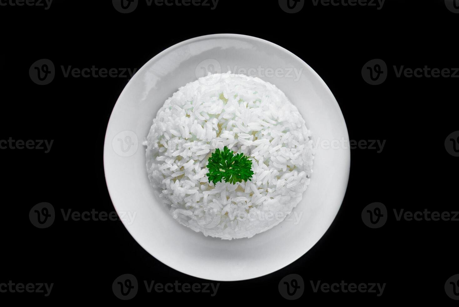 Plate with white rice serving for Vietnamese dishes on black background photo
