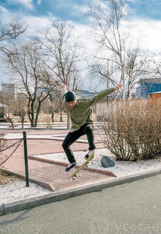 Young man riding skateboard making tricks photo