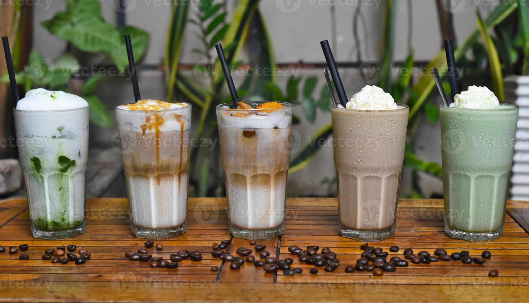 Coffee beverages with coffee beans on the wooden table in coffee shop photo