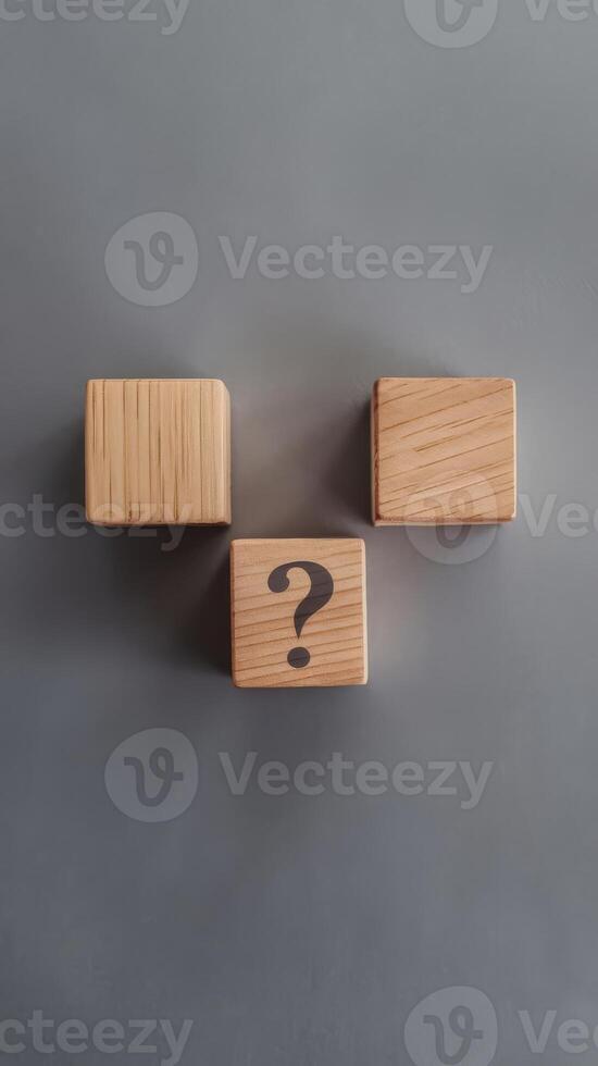 Three wooden blocks with question mark on them photo