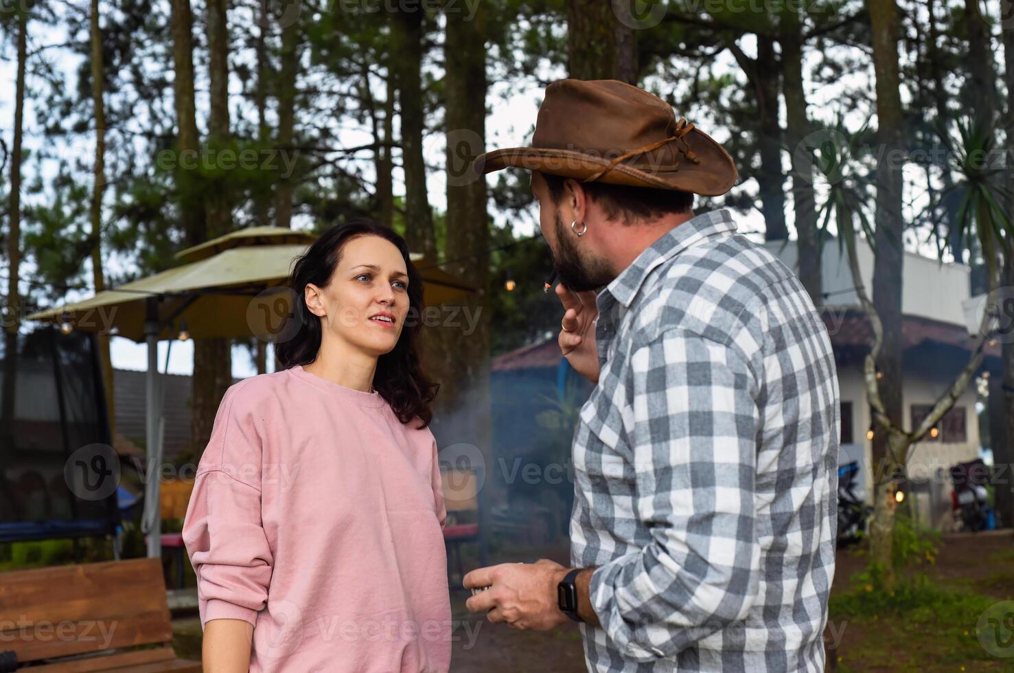 Smoking man and his wife arguing and talking photo