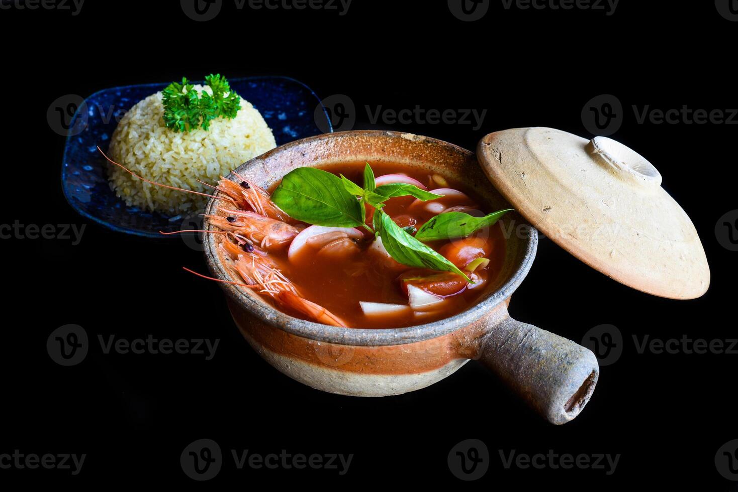 Soup tom yum with rice isolated on a black background side view photo