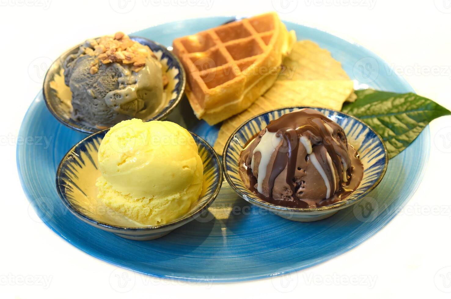 Homemade ice cream with waffle on the plate with chocolate syrup photo