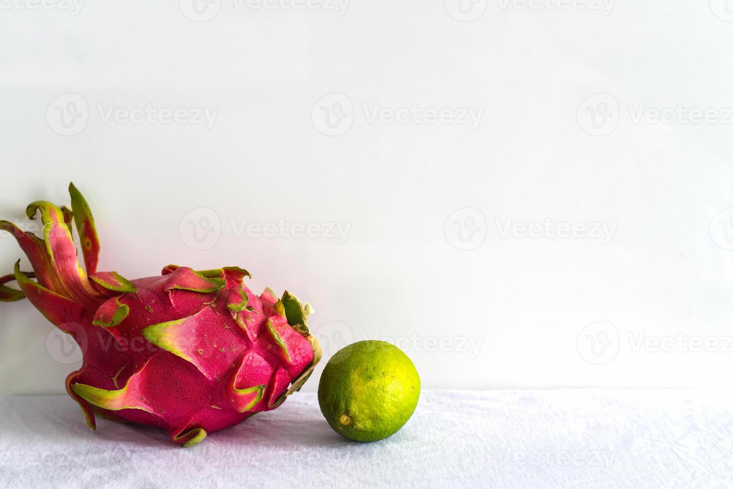 Pitaya or dragon fruit with lime on white background photo