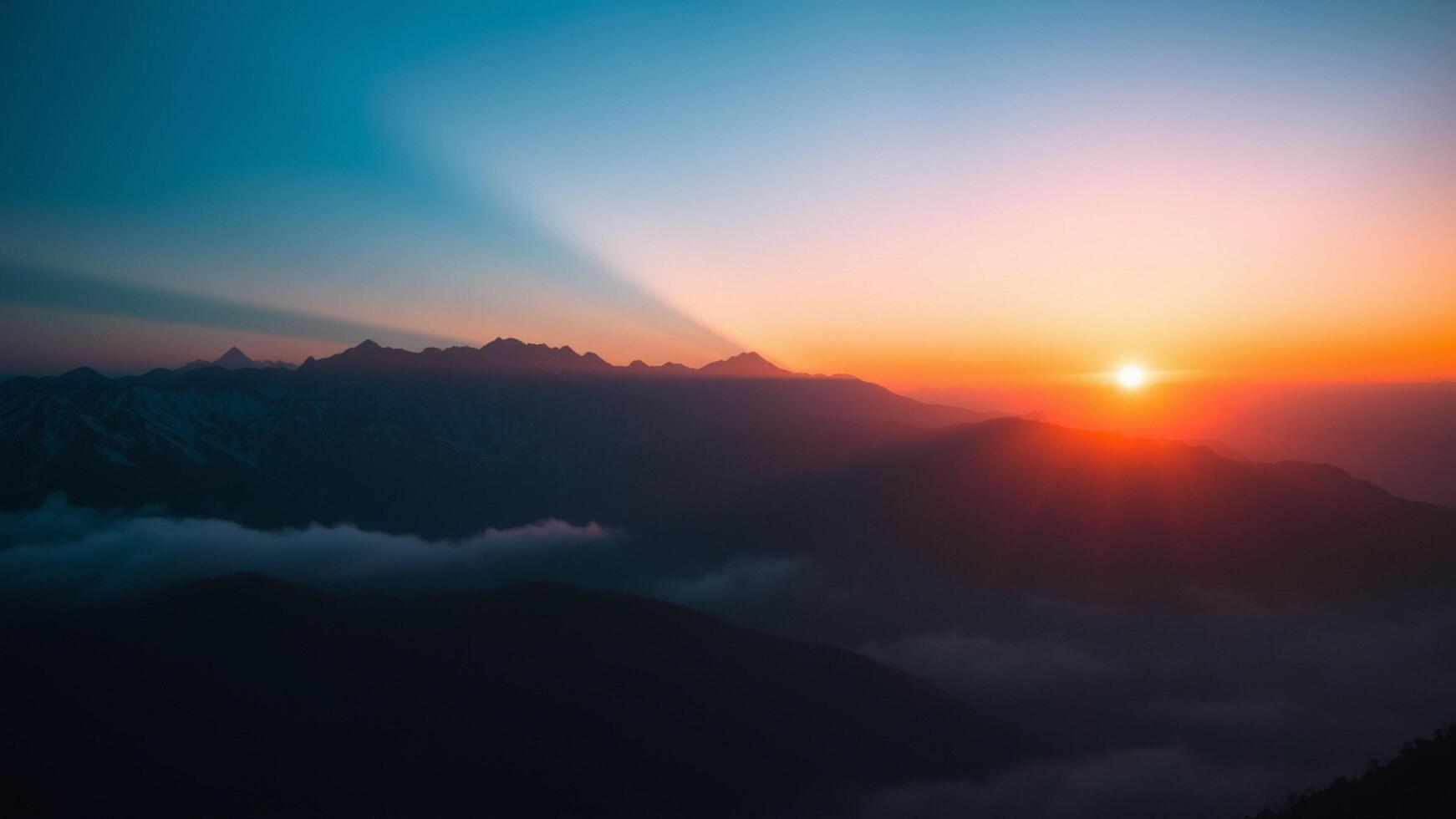 Sunrise over mountains with clouds and fog photo