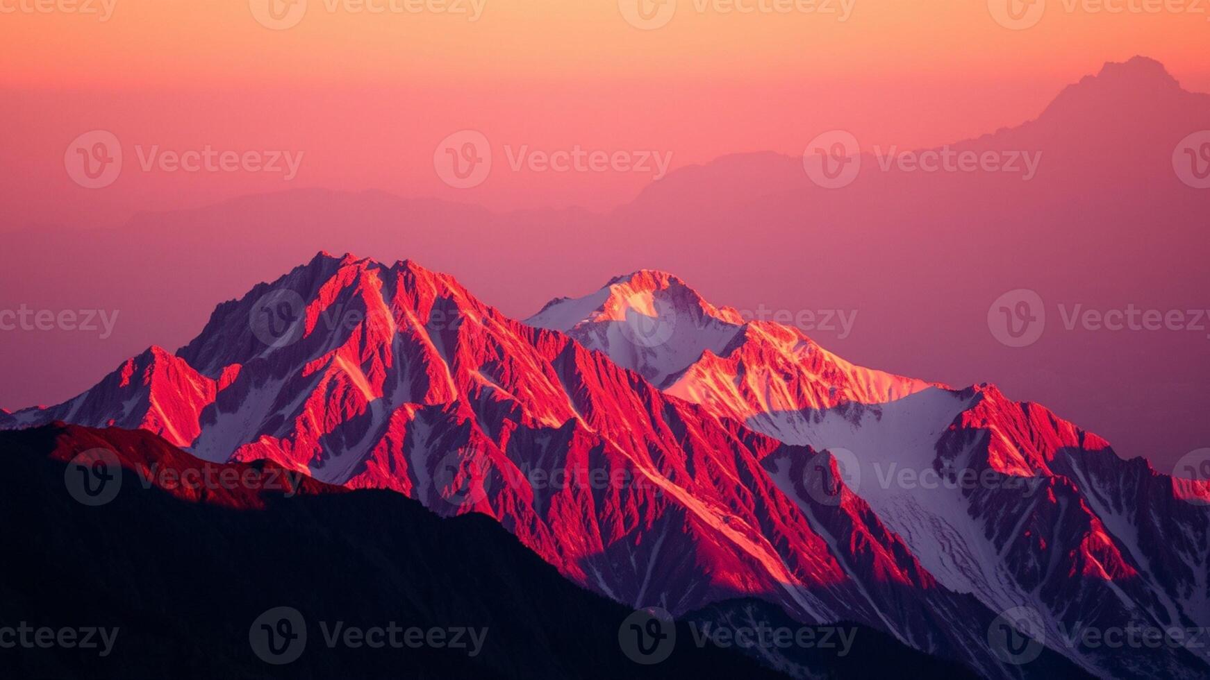 A mountain peak with a red sky photo