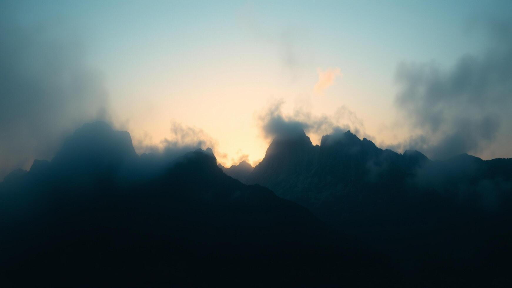 A view of the mountains at sunset with clouds photo