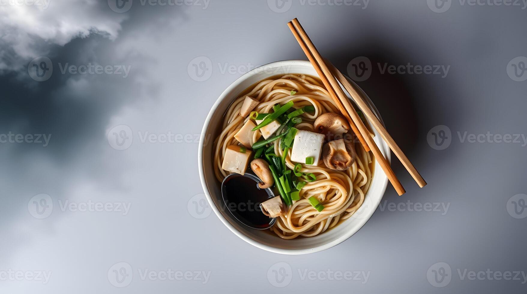 Noodles with tofu and vegetables in a bowl on a cloudy background photo