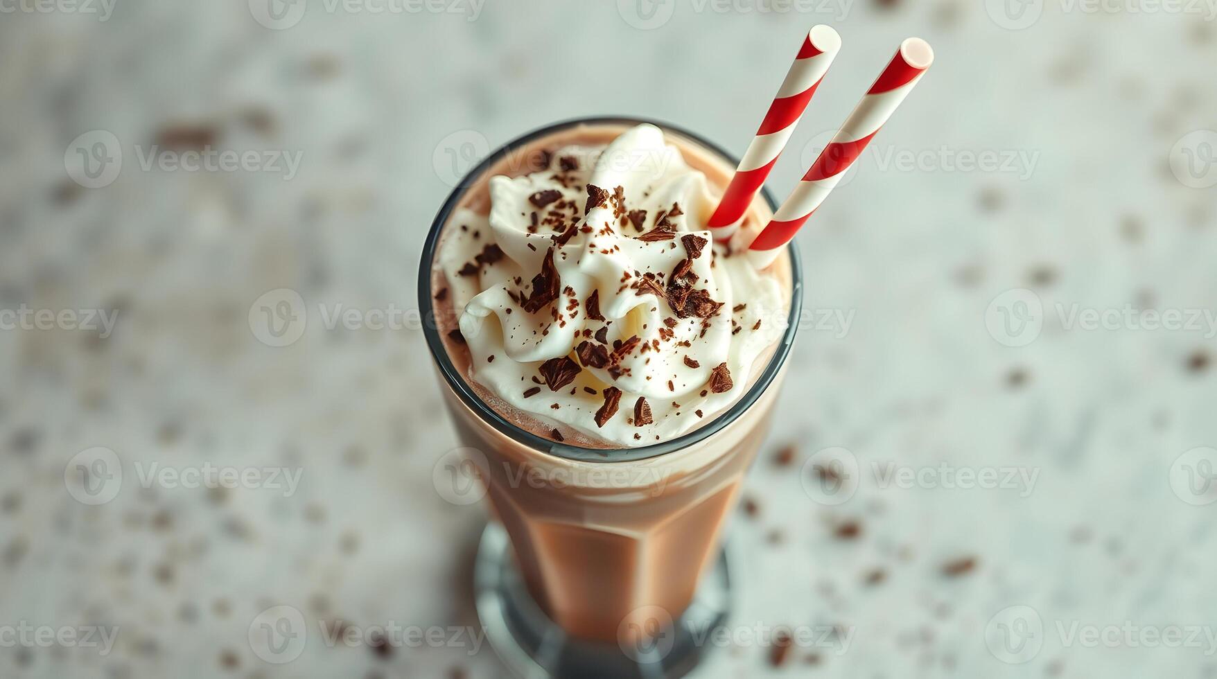 A chocolate milkshake with whipped cream and a straw photo
