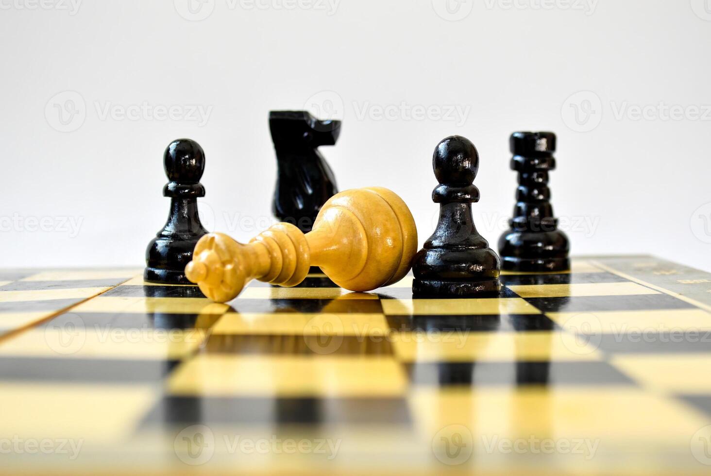 The black pawn defeated white queen on a chessboard photo