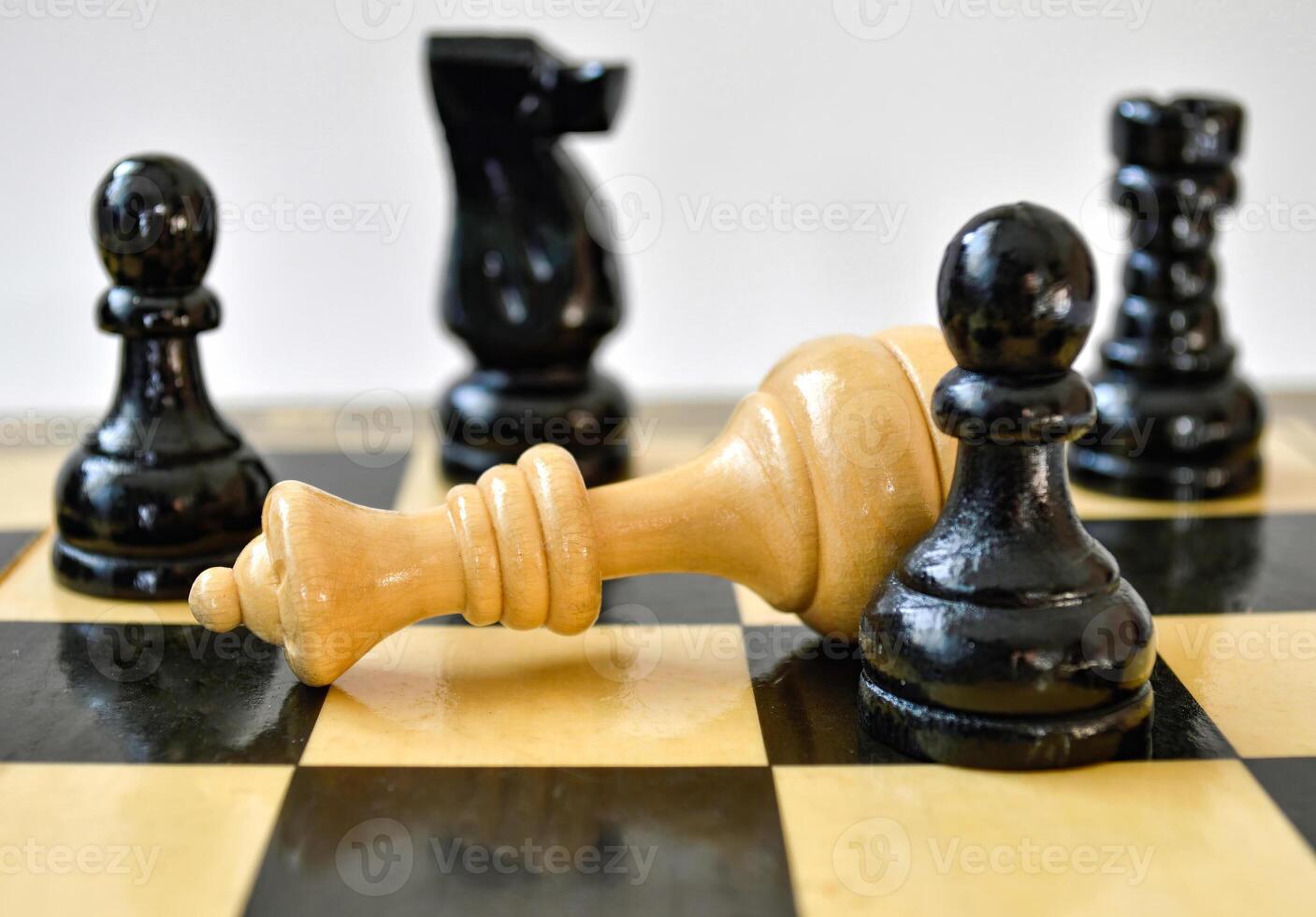 The black pawn defeated white queen on chessboard photo