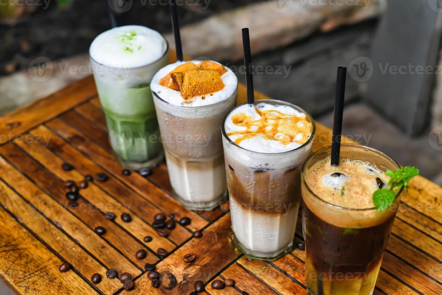 Coffee beverages with coffee beans on table in a coffee shop photo