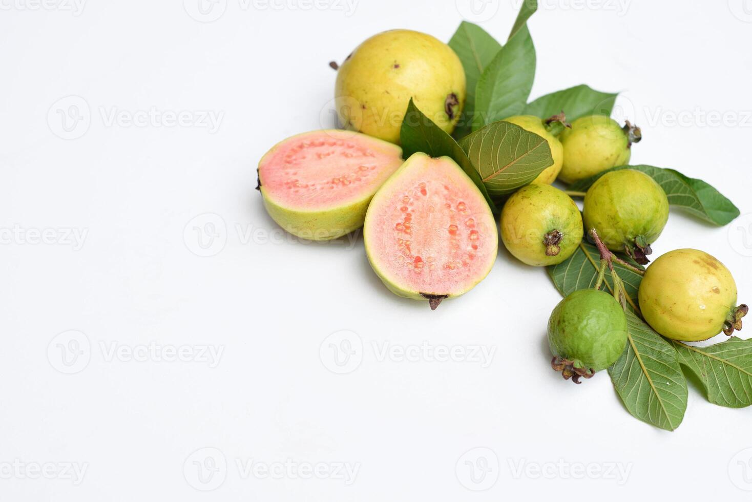 Ripe guava fruit with leaves on white background with copy space photo