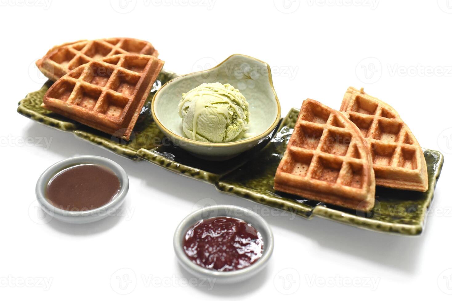 Homemade ice cream with waffle on plate with chocolate syrup and marmalade photo