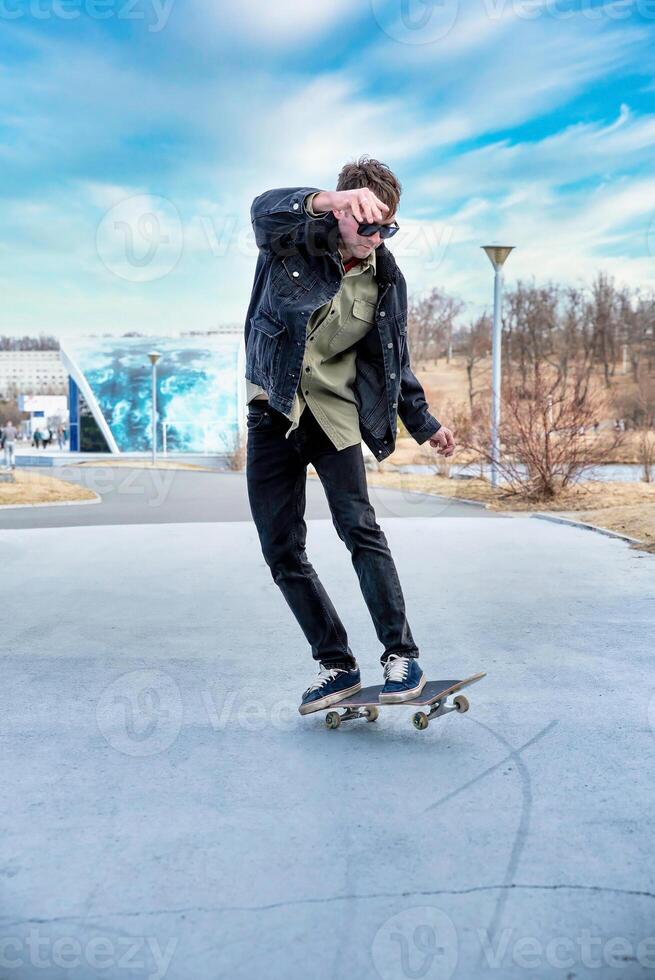 man riding a skateboard making tricks and jumps photo