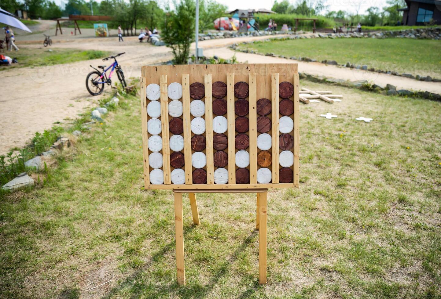 Wooden game Connect Four known as Connect 4, Four Up, Plot Four, giant figures without people photo